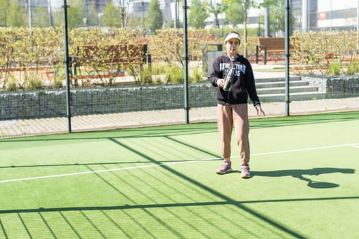 Ukraine Kyiv, April 20 2024. happy pretty girl practicing paddle sport on the paddle court. High quality photo