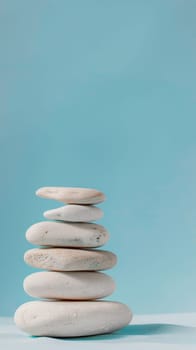 Stack of smooth white stones on a blue background.