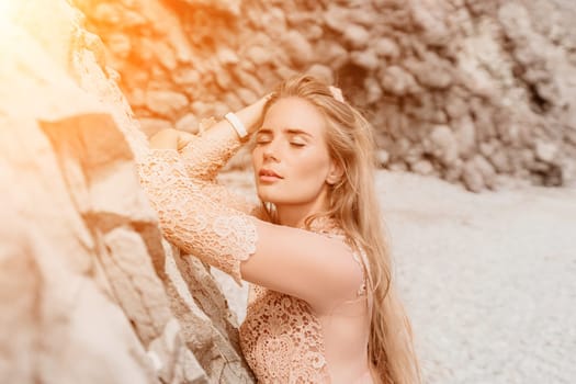 Woman travel sea. Young Happy woman in a long red dress posing on a beach near the sea on background of volcanic rocks, like in Iceland, sharing travel adventure journey