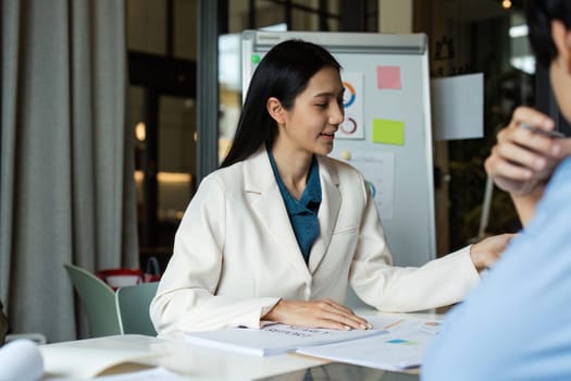 Business woman meeting and brainstorming, discussion with colleague about strategy in boardroom.