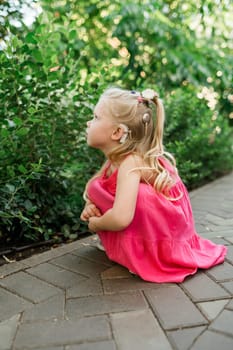 Funny baby with cochlear implant walks outdoor. Hearing aid and medicine innovating technology concept. Diversity and inclusion. Copy space.