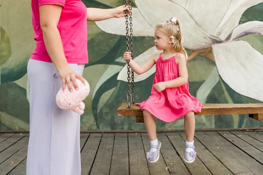 Child head with cochlear implant hearing aid. Hearing aid and medicine innovating technology and diversity concept