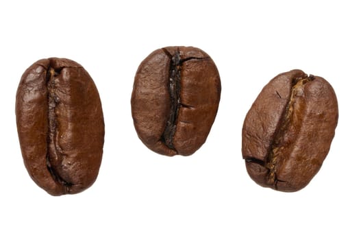 Roasted coffee beans scattered on isolated background, top view