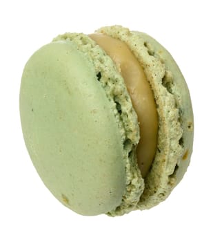 Green pistachio macaron on white isolated background, close up