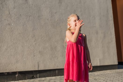 Child with hearing problem and cochlear implant dance in street, deaf kid began to hear. Hearing loss in childhood and treatment concept. Copy space and empty place for text.