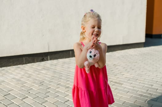 Child girl walks and have fun outdoor with cochlear implant on the head. Hearing aid and treatment concept. Copy space vertical.