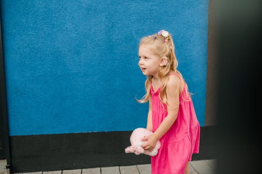 Child with hearing problem and cochlear implant dance in street, deaf kid began to hear. Hearing loss in childhood and treatment concept. Copy space and empty place for text.