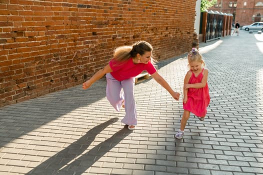 Child girl with cochlear implant with her mother spend time outdoor. Hear impairment and deaf community concept. Deaf and health concept. Diversity and inclusion. Copy space.