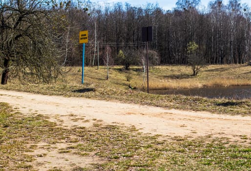 Shot of the street in the russian village. Signboard says no swimming