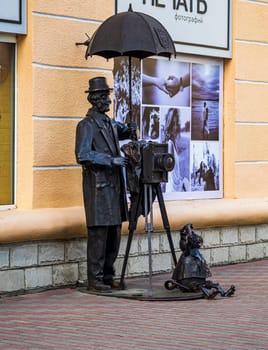 Brest, Belarus - 03.03.3024 - Funny sculpture of the photographer in the front of the photo studio