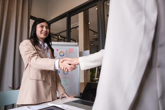 Successful negotiation, handshake, two businessmen shaking hands with partners to celebrate successful completion of deal.