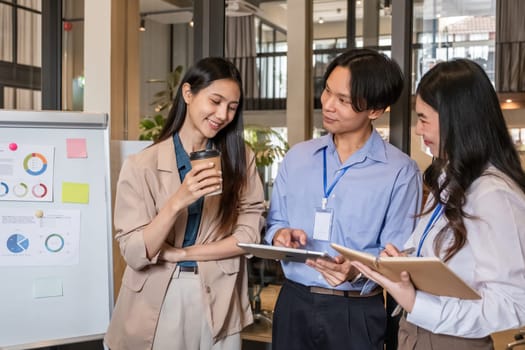 A team of businessmen stood and talked and exchanged ideas. Brainstorm together in the office.