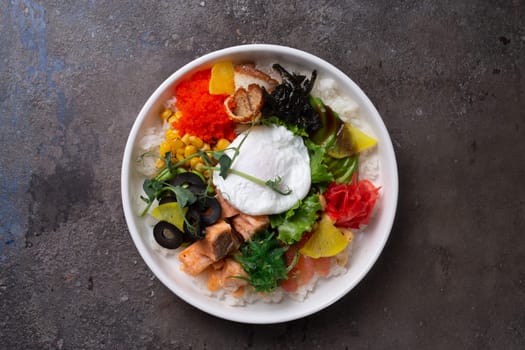 A delicious and healthy poke bowl filled with fresh salmon, avocado, cucumber, edamame, and topped with a poached egg.