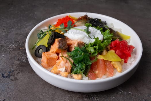 A delicious and healthy poke bowl filled with fresh salmon, a soft-boiled egg, and an assortment of colorful vegetables.