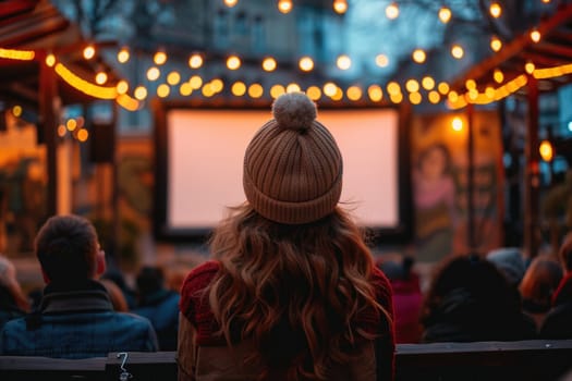 people watching outdoor cinema, big screen show. view from behind. ai generated