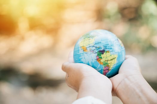 World Earth Day signifies embracing Green Energy, ESG, and Sustainable Resources. Hold a green leaf and the globe, demonstrating responsibility and environmental care in support of our planet.