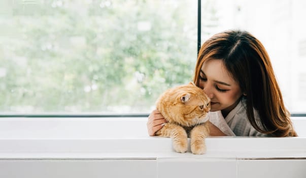 An attractive adult woman is enjoying a relaxing bath in her bathroom, accompanied by her adorable Scottish Fold cat. This heartwarming image captures the essence of pet love and tranquility.