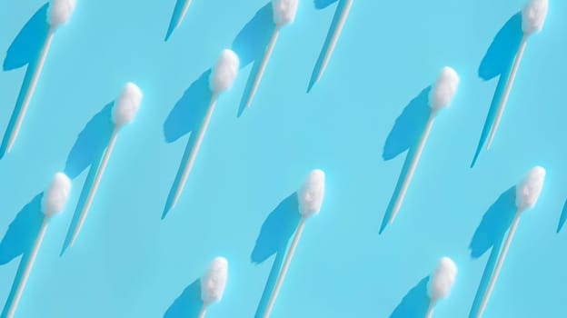 Pattern of a cotton swabs on a blue background.