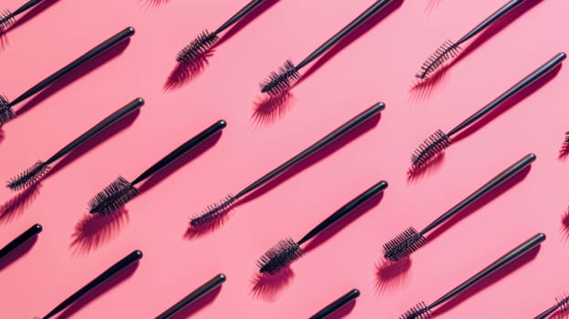 Diverse array of mascaras brush on pink background.
