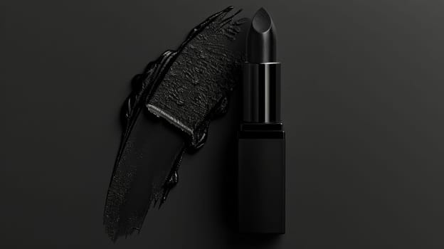 Close up of black lipstick on black background.