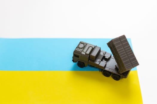 Artillery rocket system are aimed to the sky and soldier at sunset with Ukrainian flag. Multiple launch rocket system. High quality photo