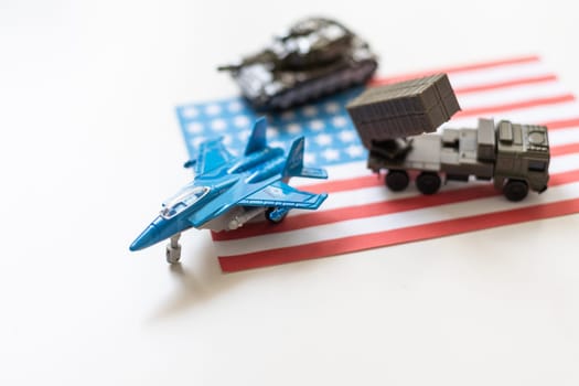 Miniature toy soldiers in battle scene with american flag background , Memorial Day concept. High quality photo
