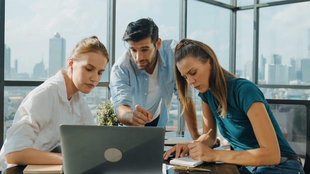 Group of skilled businesspeople sharing idea about marketing plan. Professional business team working together, discussing, talking at meeting table with laptop, document with cityscape. Tracery