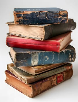 A stack of old books sits on a brown wooden shelf, with a blue book on top. The books have varying font styles on their linen book covers, made of natural materials