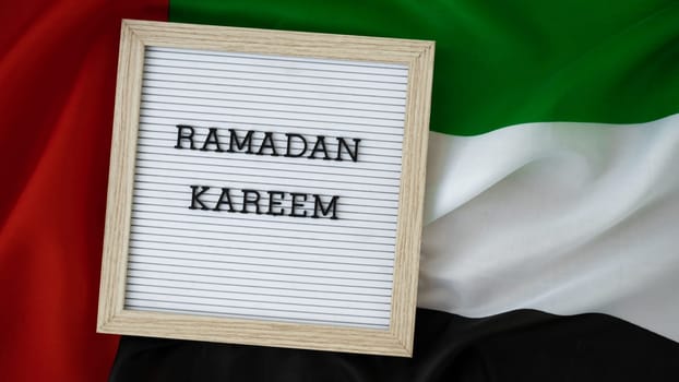 Message RAMADAN KAREEM - happy holidays waving UAE flag on background concept. Greeting card advertisement. Commemoration Day Muslim Blessed holy month public holiday