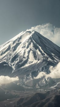 Snowy mountain peak with clouds.