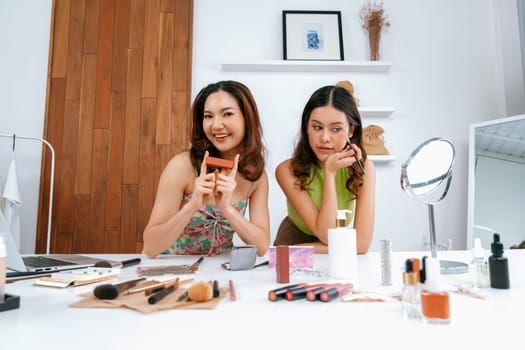 Woman influencer shoot live streaming vlog video review makeup uttermost social media or blog. Happy young girl with cosmetics studio lighting for marketing recording session broadcasting online.