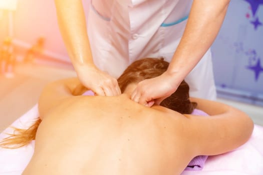 Facial massage. A woman is given a massage in a beauty salon. Close-up