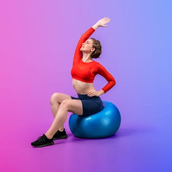 Full body length gaiety shot athletic and sporty young woman with fitness exercising ball in standing posture on isolated background. Healthy active and body care lifestyle.