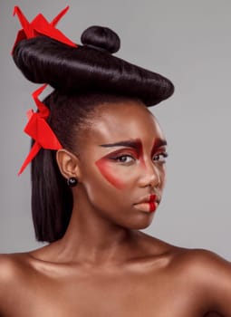 Traditional, makeup and origami with portrait of black woman in studio for creative, cosmetics and asian aesthetic. Beauty, paper design and model for heritage, art and confidence on gray background.