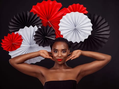 Portrait, African woman and smile with origami on hair in studio background for fashion, art and decor. Female person, artist and glamour for creativity, beauty or design with pride or confidence.