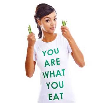 African woman, backdrop and portrait for health or fashion with statement, tshirt with announcement for vegan. Female model, clothes and white background for consumer awareness, vegetables for diet.