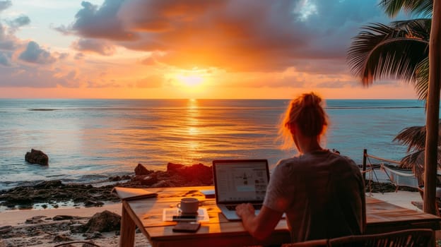 Woman working remotely on her laptop at a beach bar during a stunning sunset