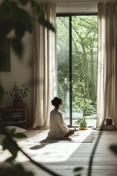 Early morning yoga session in a room with natural light and a view of lush greenery