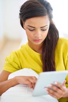 Woman, tablet and home on couch for streaming, fun or online with chat, social media and scrolling. Female person, house and relax for break, communication and internet with tech, typing or browsing.