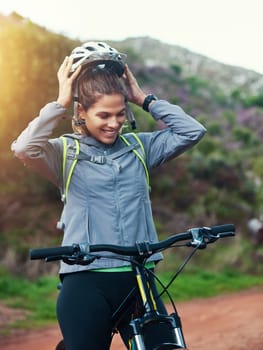 Helmet, woman and mountain bike in nature, fitness and cycling sports for adventure on path. Female person, athlete and bicycle for exercise in outdoors, cardio and training for off road competition.