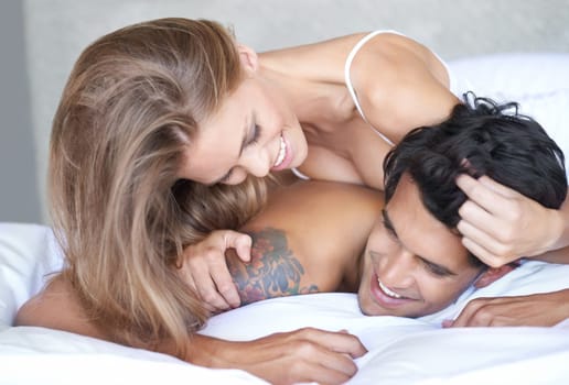 Couple, relax and play in bed in morning, love and romance bonding in home for relationship. Happy people, wake up and security in marriage connection, care and rest in hotel or playful on honeymoon.