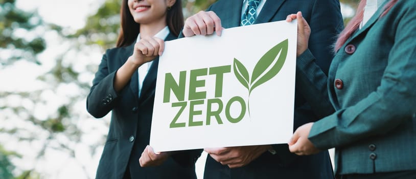 Group of business people stand united, holding eco-friendly idea and concept for environmental awareness campaign by business corporate to embrace net zero emission and environmental friendly. Gyre