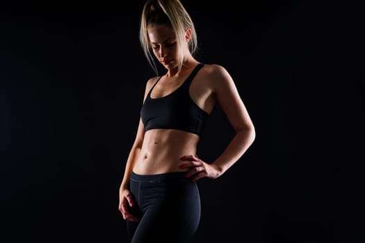 Middle aged woman doing fitness workout, standing on activewear with abs and muscles, smiling happy