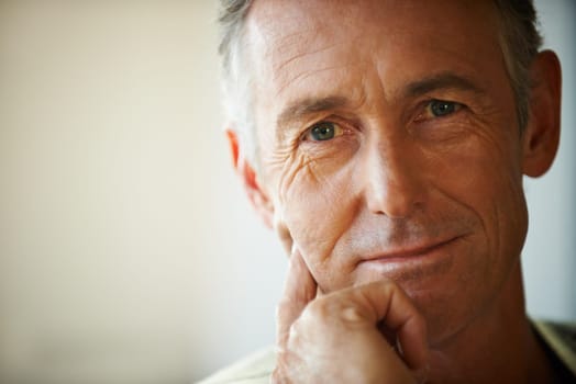 Headshot, senior man and portrait thinking about retirement at home, apartment and living room with mockup space. Hand, idea and mature male person in house to relax in lounge for elderly care.