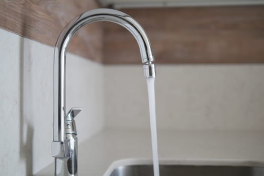 water pouring from a faucet tap slow motion .