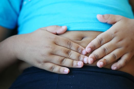 child suffering stomach pain close up..