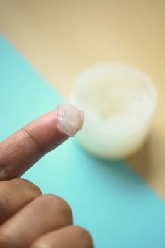 Close up of man hand using petroleum jelly .