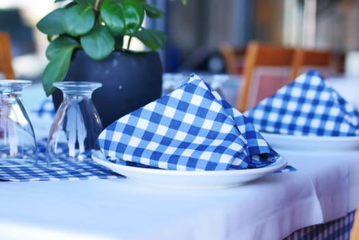 served and decorated round festive table in a restaurant .