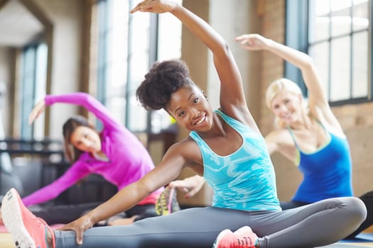 Black woman, portrait and instructor at yoga class, stretch and yogi for exercise on mat. Female person, trainer and confident for pilates or spiritual fitness, flexibility and happy for gym activity.