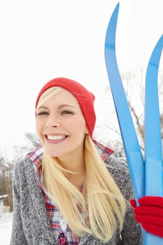 Portrait, skier or happy woman in winter with snow, beanie or smile in Sweden on holiday vacation. Female person, ready or face of girl on outdoor trip for travel, adventure or wellness in nature.